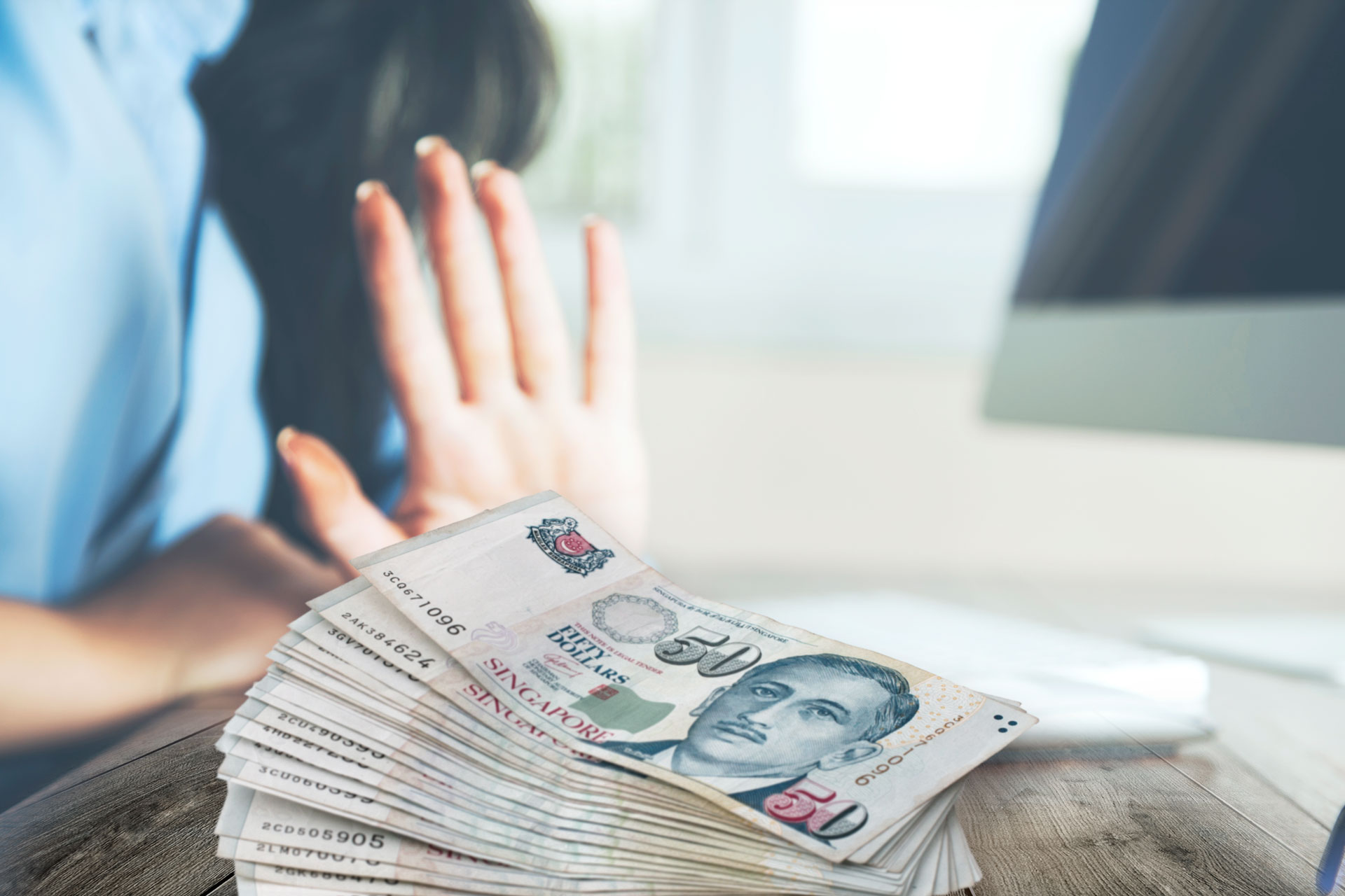 A lady holding her hand up refusing the stack of fifty dollar bills from an unlicensed money lender